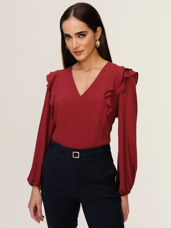 Blusas femininas para trabalhar: modelo vestindo uma blusa de crepe manga longa na cor vinho.