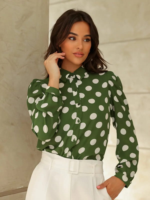 Blusa de poá: modelo vestindo uma blusa de poá com manga longa verde e bolas brancas.