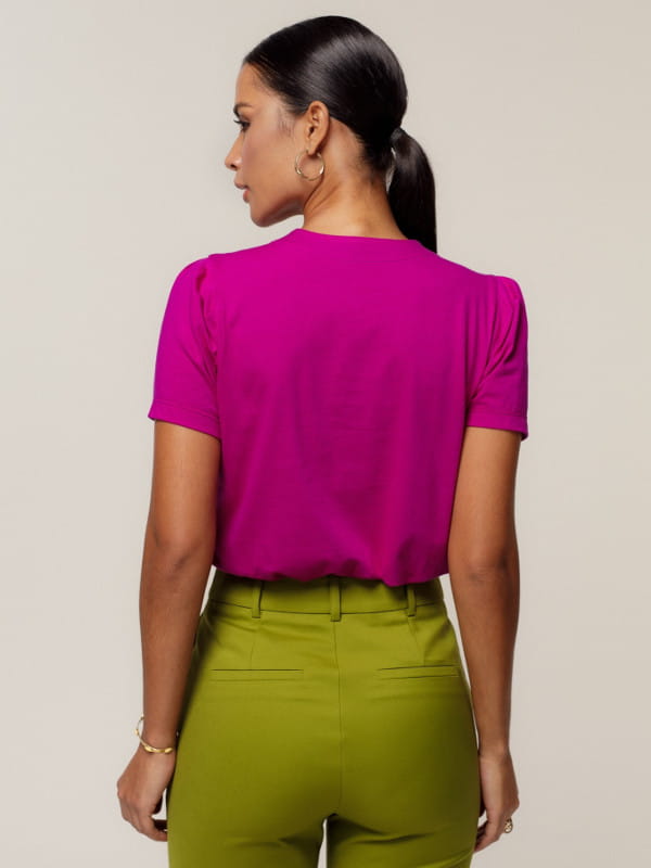 Cores que combinam com fucsia: modelo vestindo uma blusa de malha decote V - costas.