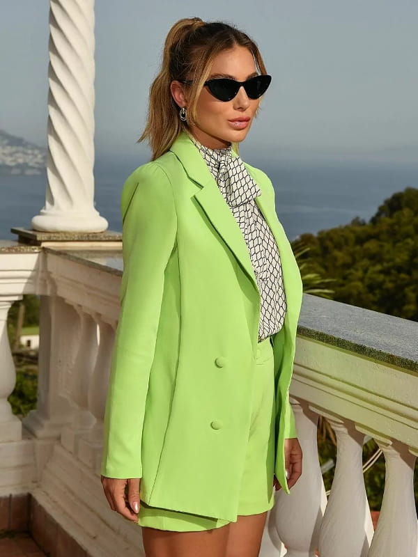 Looks com blazer verde: modelo vestindo um blazer verde alfaiataria com short social - perfil.